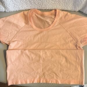 Lululemon swiftly waist length tee in light orange size 10